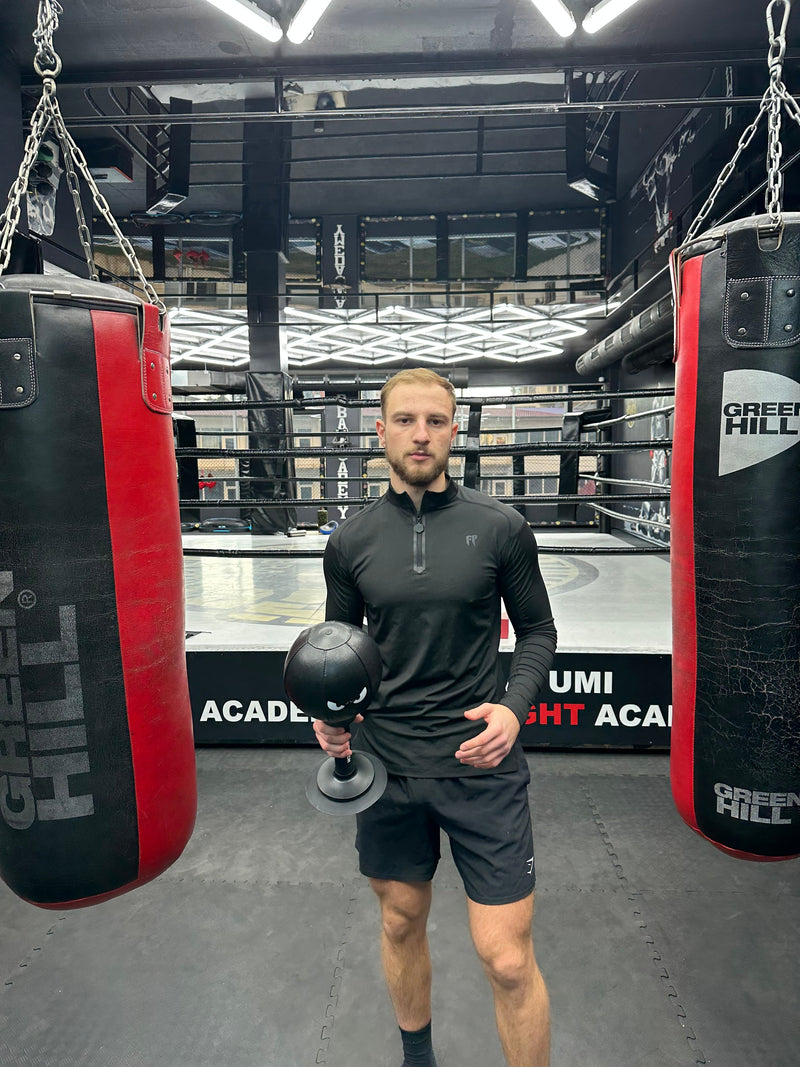 A FUNPUNCH founder holding the bag at a boxing gym
