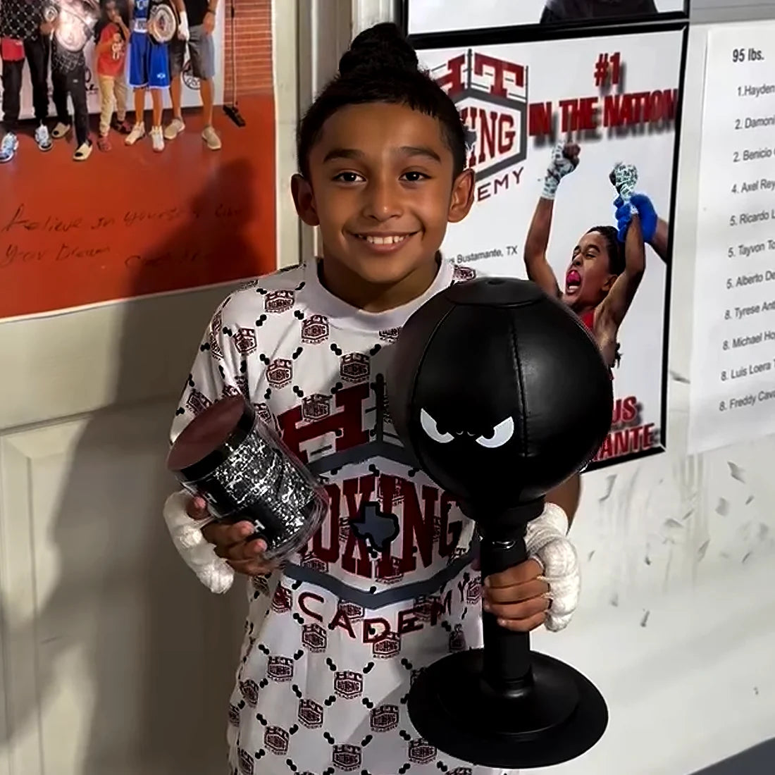 Smiling young boxer holding a black FUNPUNCH Rage-Bag